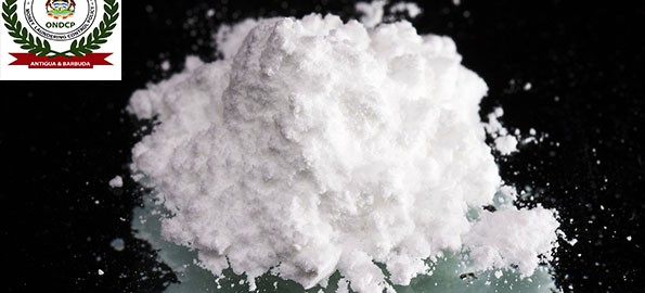 Cocaine drugs heap on a black mirror, close up view